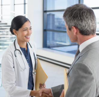 Female doctor shaking hands with healthcare consultant